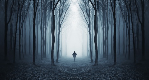man in a dark forest